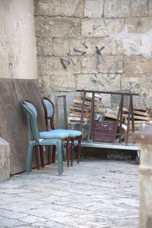 De vieilles chaises appuyées contre un mur de pierre, Tarente